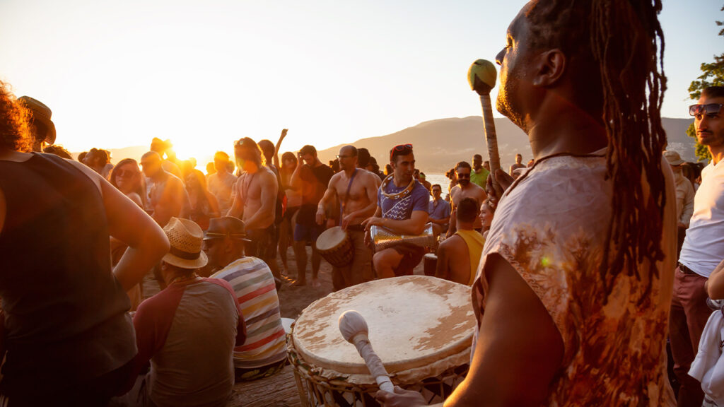 Attendees bang on their drums while experience the Magic of the Treasure Island Drum Circle!