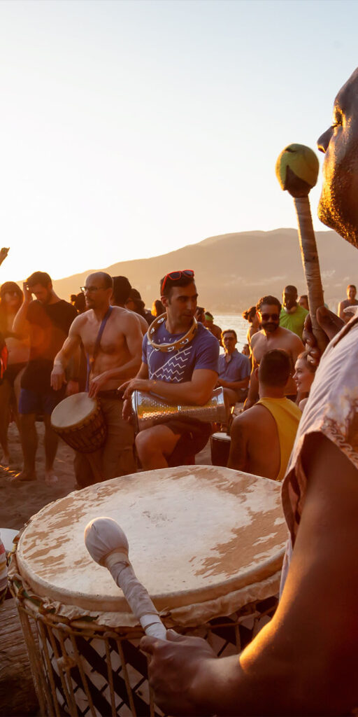 Attendees bang on their drums while experience the Magic of the Treasure Island Beach Drum Circle!